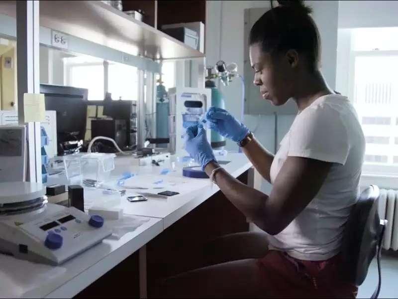 Black woman student working in a science lab